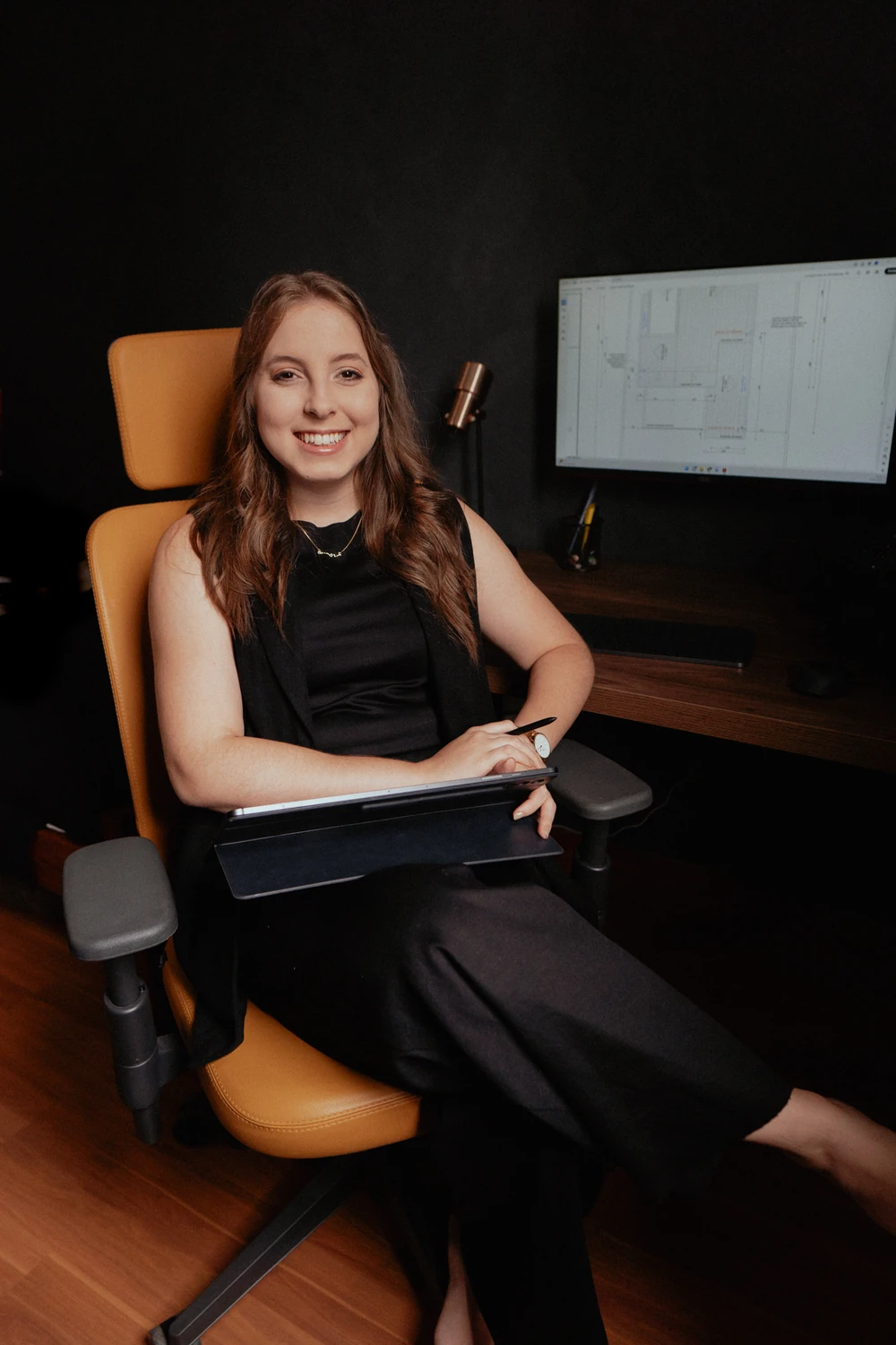 Juliana Machado at her desk, smiling
